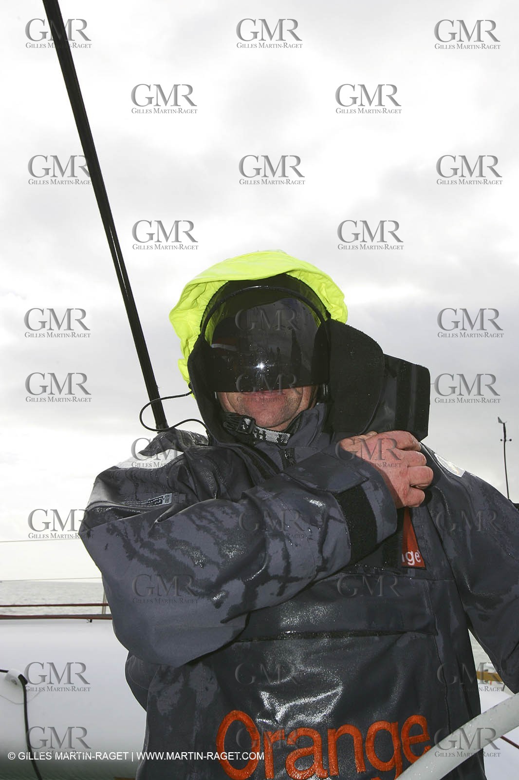 Orange II  - 2005 Jules Verne Trophy - Training in Bay of Biscay - Lionel Lemonchois + helmsan strong wind helmett-