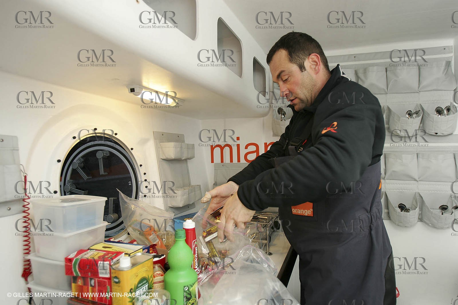 Orange II - Jules Verne Trophy 2004 - Jean-Baptiste Epron preparing food in the galley